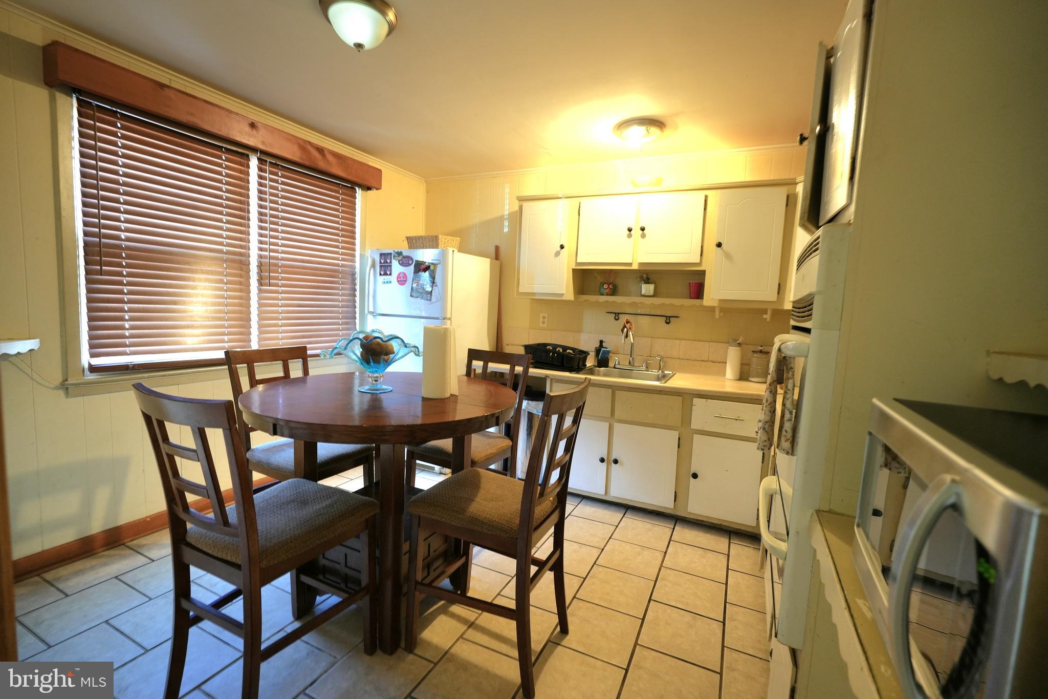 9274 Angus Place Philadelphia, PA 19114 - Photo 2 of 10 a view of a dining room with furniture and a window