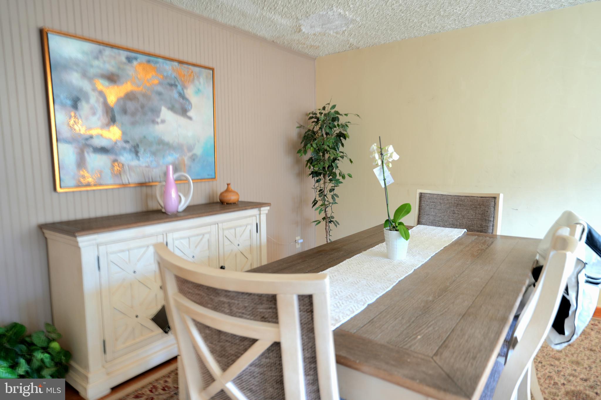 9274 Angus Place Philadelphia, PA 19114 - Photo 3 of 10 a view of a dining room with furniture and a potted plant