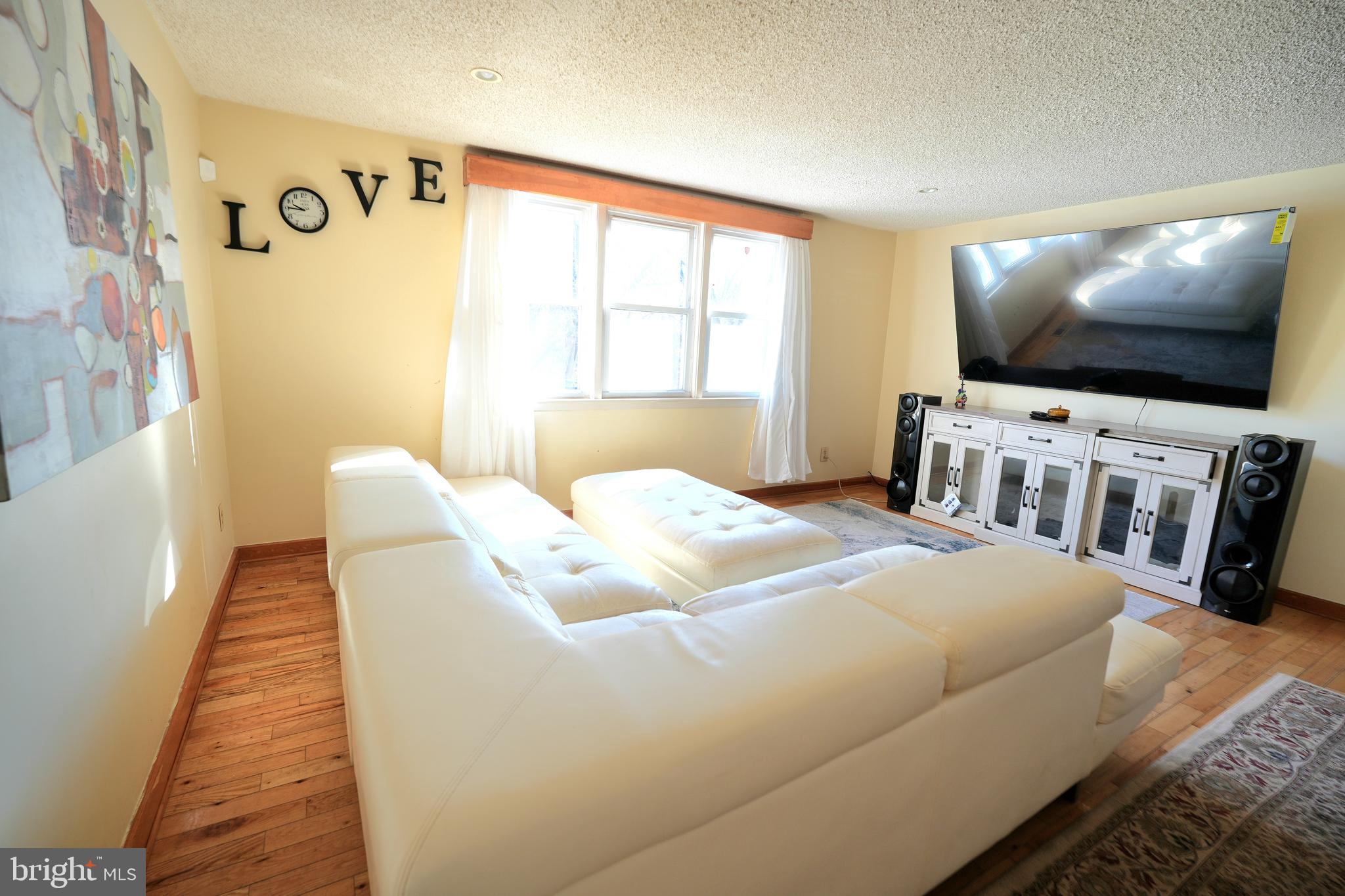 9274 Angus Place Philadelphia, PA 19114 - Photo 4 of 10 a bedroom with a bed and a flat screen tv