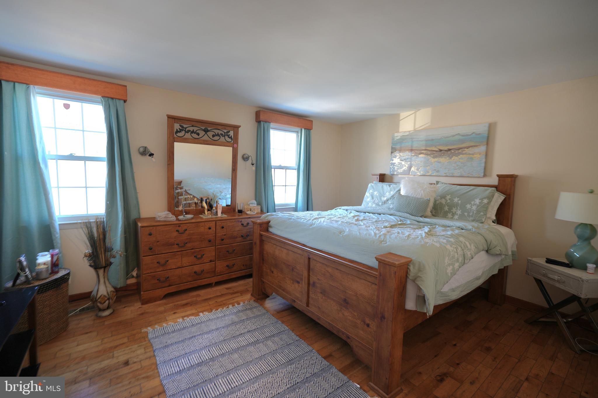 9274 Angus Place Philadelphia, PA 19114 - Photo 6 of 10 a bedroom with a bed and wooden floor