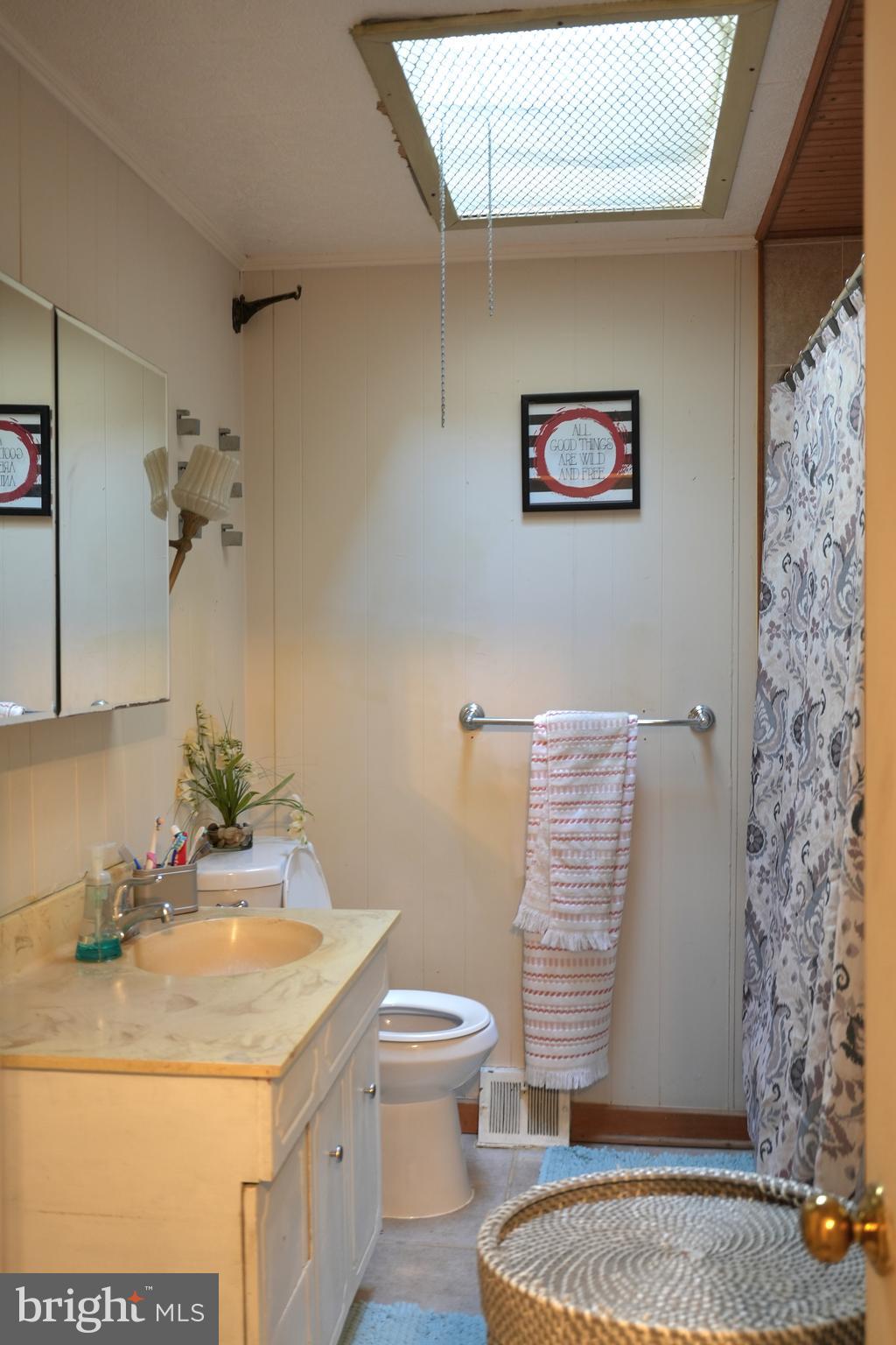 9274 Angus Place Philadelphia, PA 19114 - Photo 7 of 10 a bathroom with a granite countertop sink and a mirror