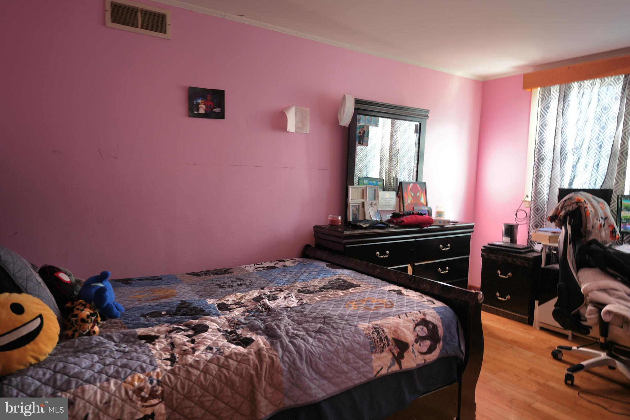 9274 Angus Place Philadelphia, PA 19114 - Photo 9 of 10 a bedroom with a bed and wooden floor