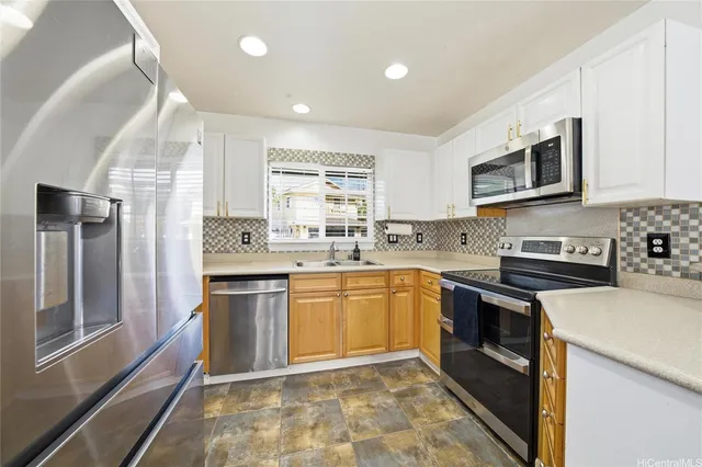 a kitchen with stainless steel appliances granite countertop a stove sink microwave and cabinets