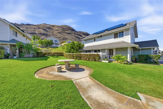 a view of an house with backyard porch and outdoor kitchen