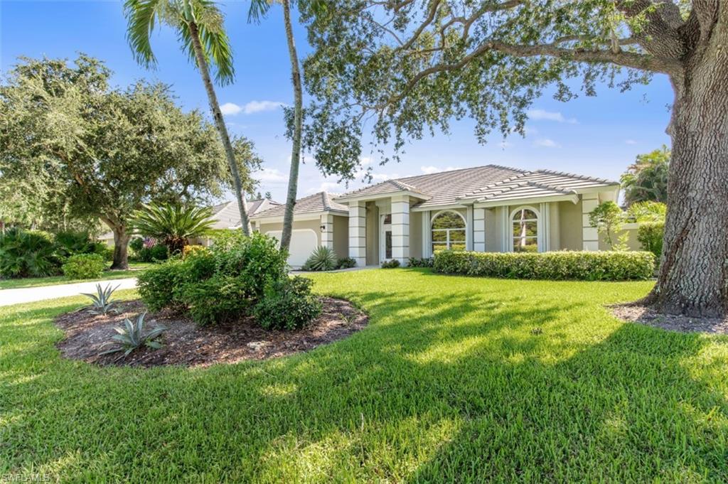 11774 Longshore Way West Naples, FL 34119 - Photo 1 of 35 a front view of a house with a garden