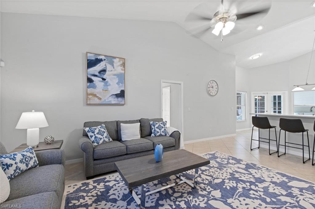 11774 Longshore Way West Naples, FL 34119 - Photo 11 of 35 a living room with furniture and a rug