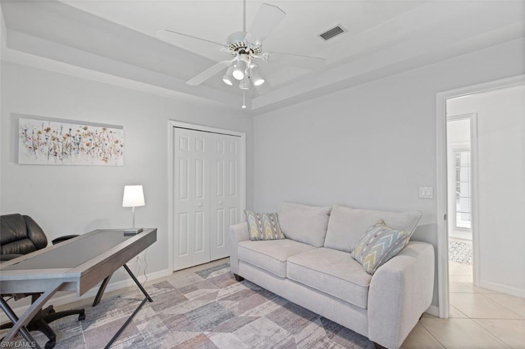 11774 Longshore Way West Naples, FL 34119 - Photo 14 of 35 a living room with furniture and a chandelier