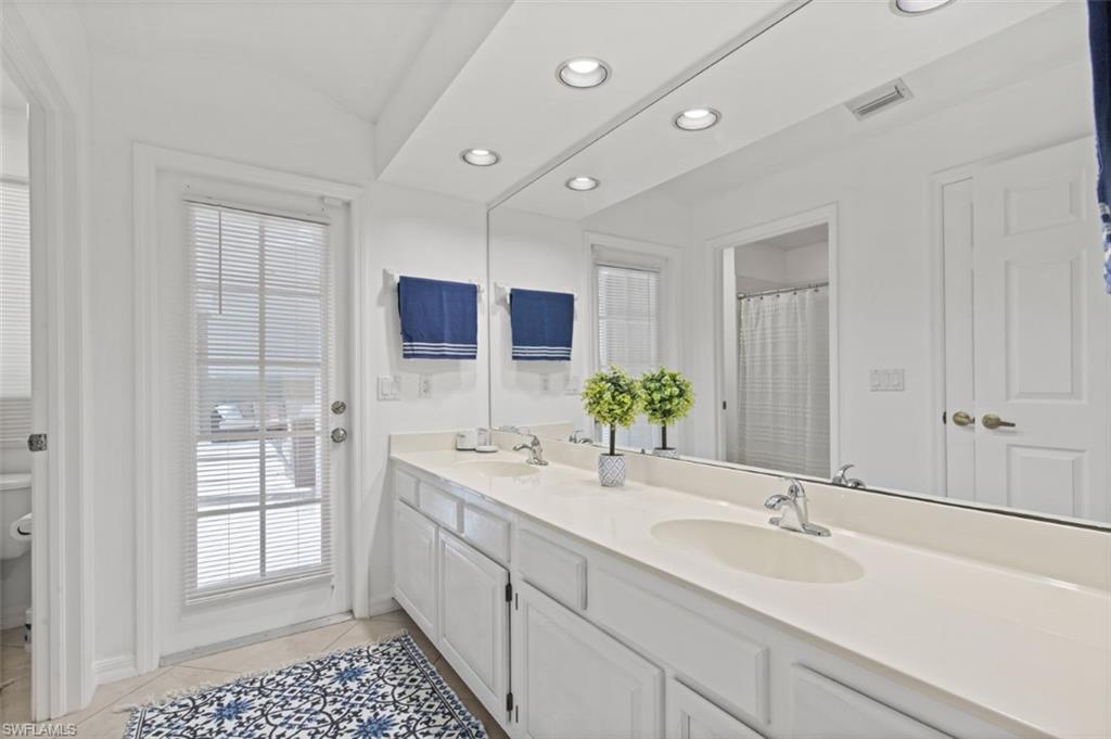 11774 Longshore Way West Naples, FL 34119 - Photo 15 of 35 a bathroom with a sink and a mirror
