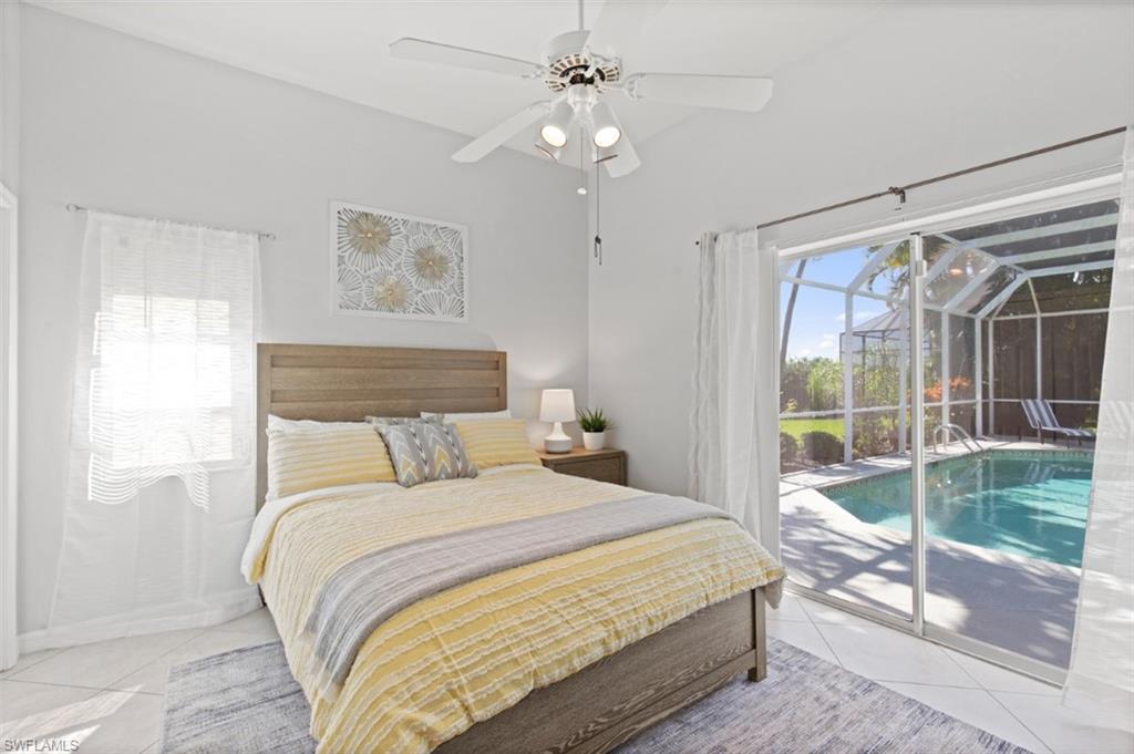 11774 Longshore Way West Naples, FL 34119 - Photo 18 of 35 a bedroom with a large bed and a large window with outer view