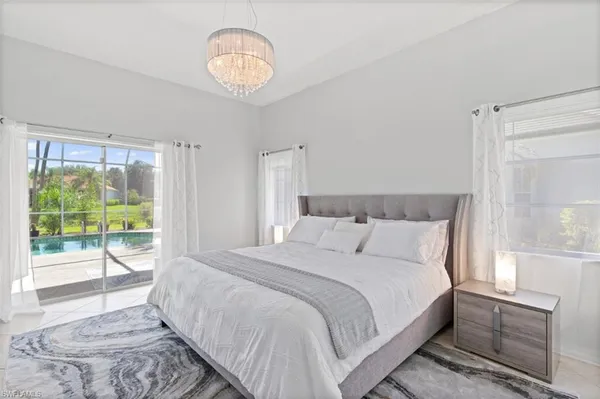 a bedroom with a large bed and a large window