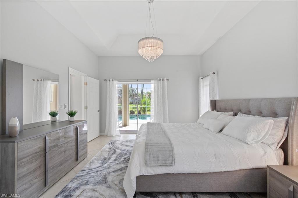 11774 Longshore Way West Naples, FL 34119 - Photo 22 of 35 a bedroom with a bed and window