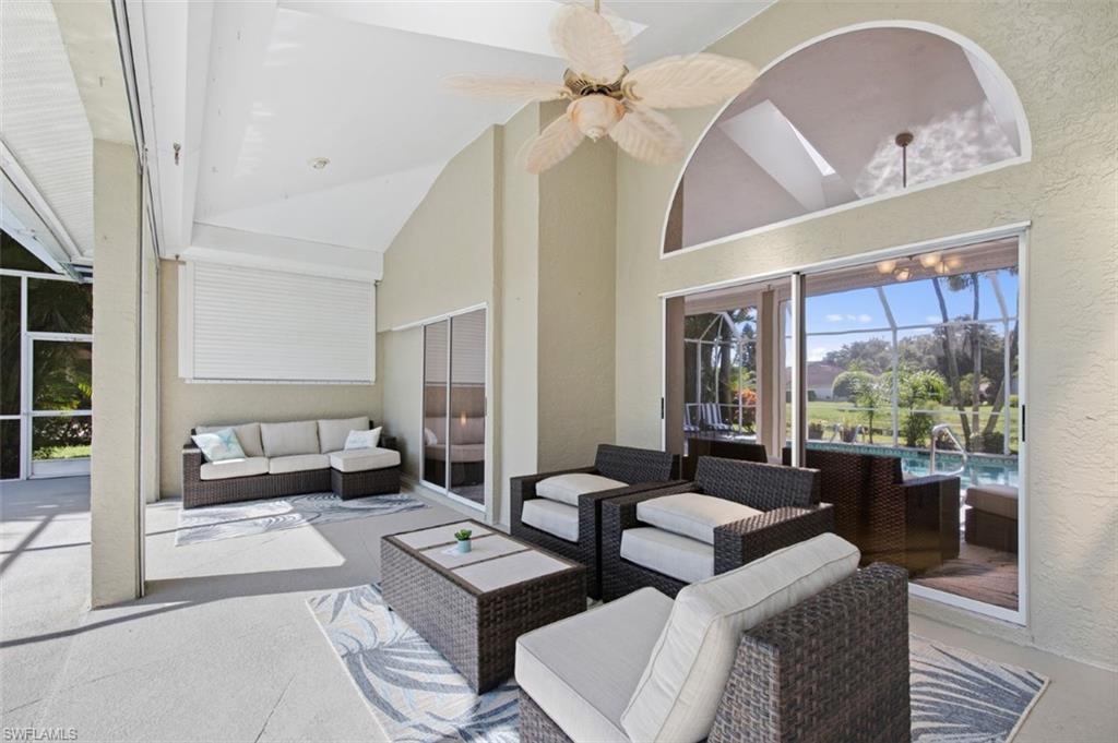 11774 Longshore Way West Naples, FL 34119 - Photo 26 of 35 a living room with furniture and a large window