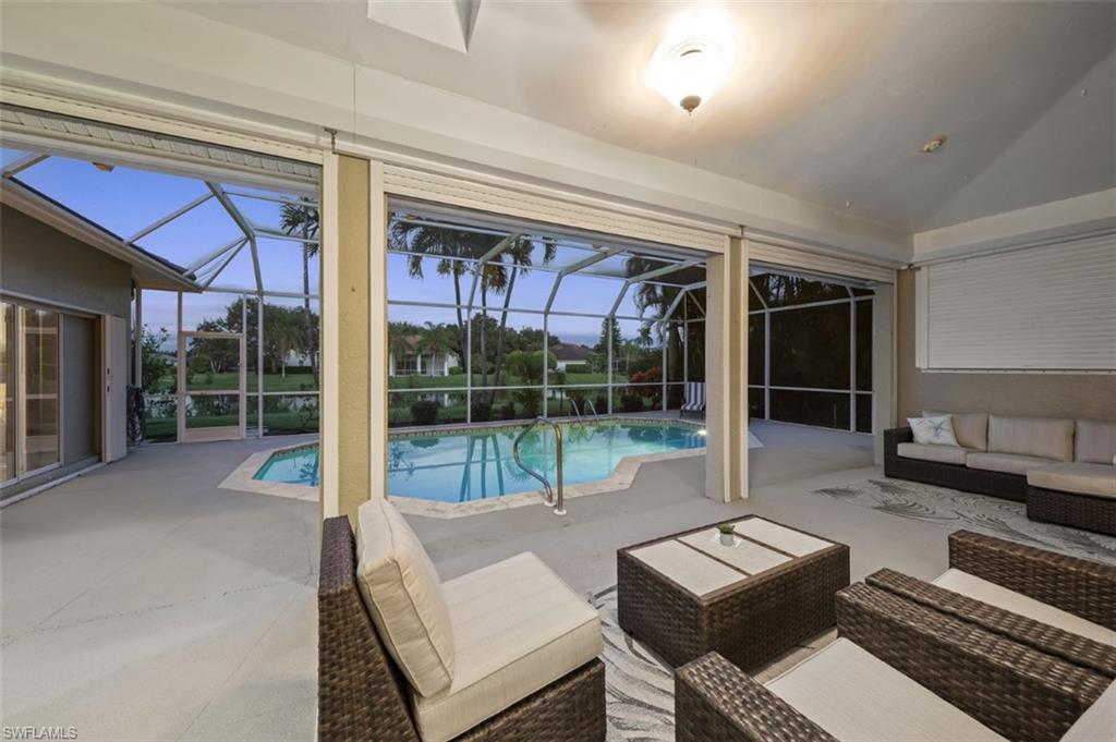 11774 Longshore Way West Naples, FL 34119 - Photo 28 of 35 a living room with furniture and a floor to ceiling window