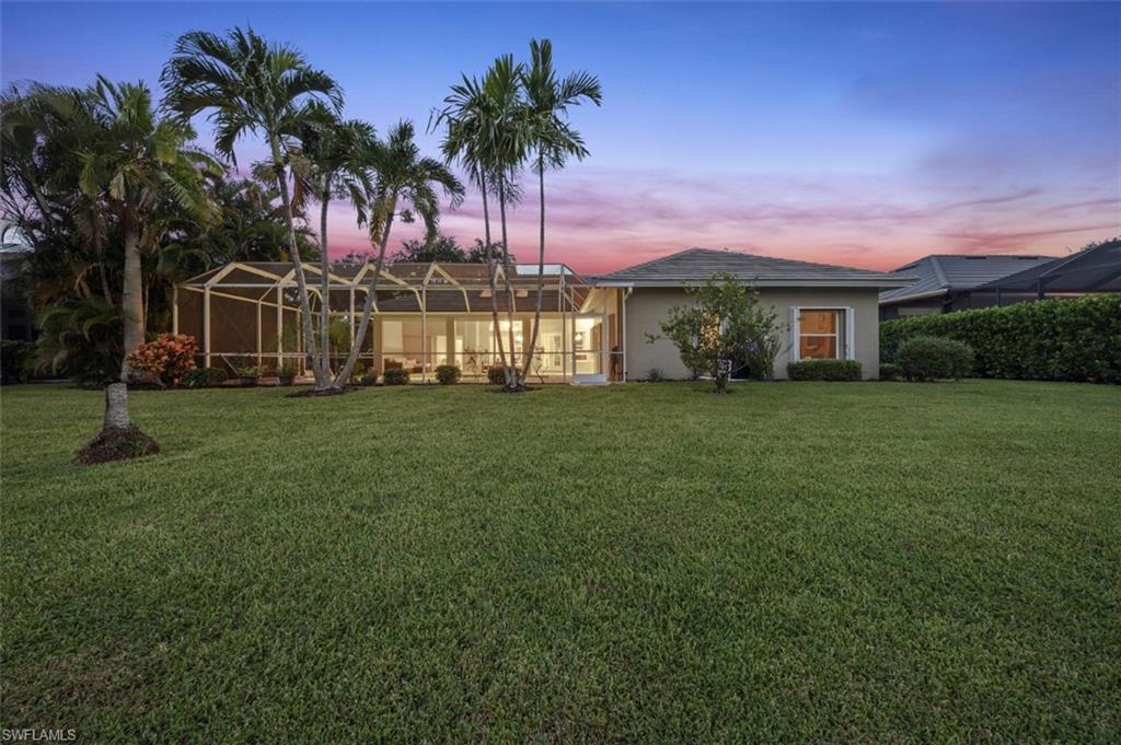 11774 Longshore Way West Naples, FL 34119 - Photo 30 of 35 a front view of house with yard and green space