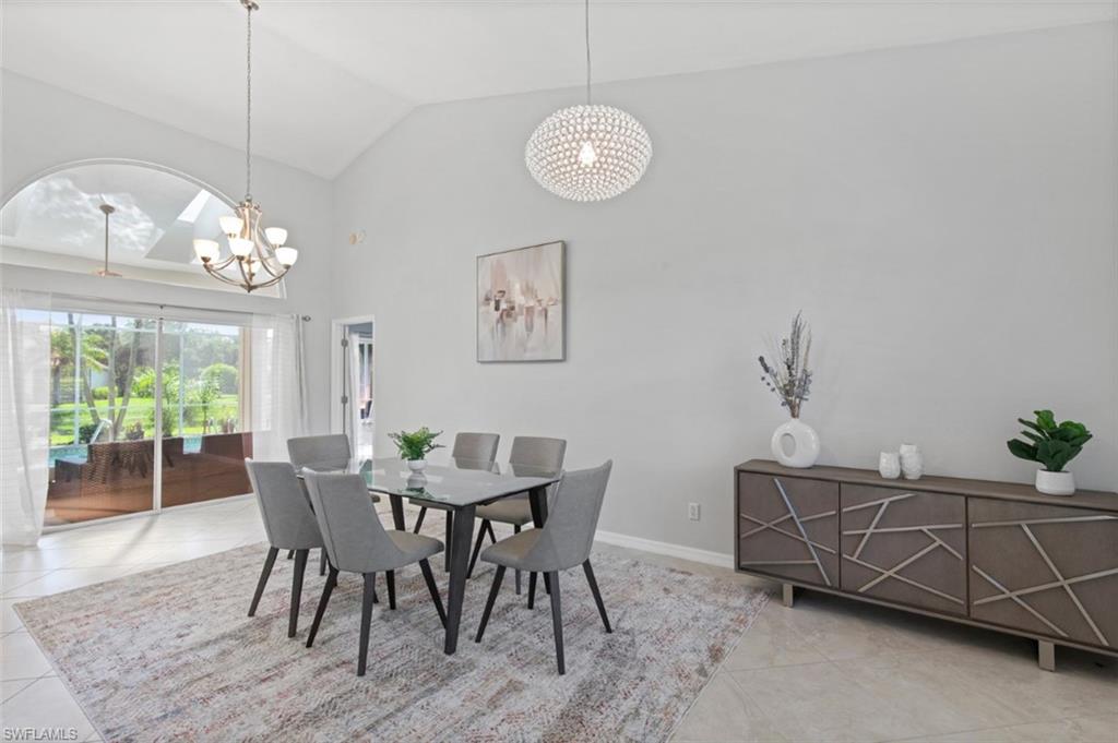 11774 Longshore Way West Naples, FL 34119 - Photo 6 of 35 a view of a dining room with furniture a chandelier and wooden floor