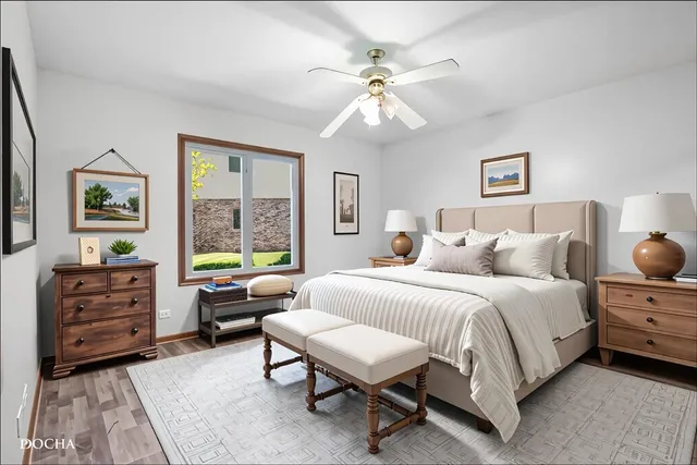 a spacious bedroom with a bed a couch and a window