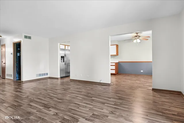 a view of a room with wooden floor and cabinet