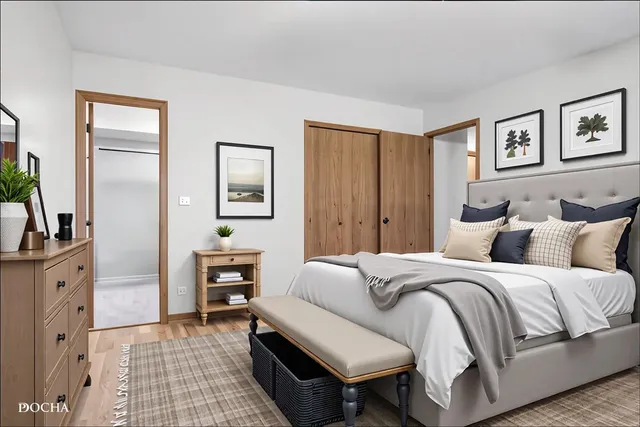 a bedroom with a bed and a chandelier