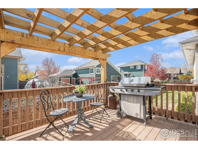 a view of a patio with a dining table and chairs with wooden floor