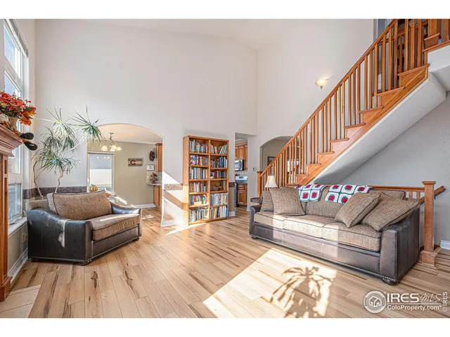 a living room with furniture and stairs