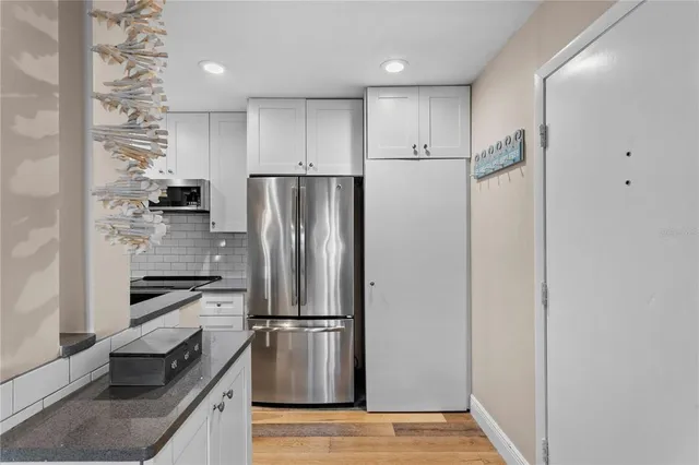 a kitchen with a refrigerator and a sink