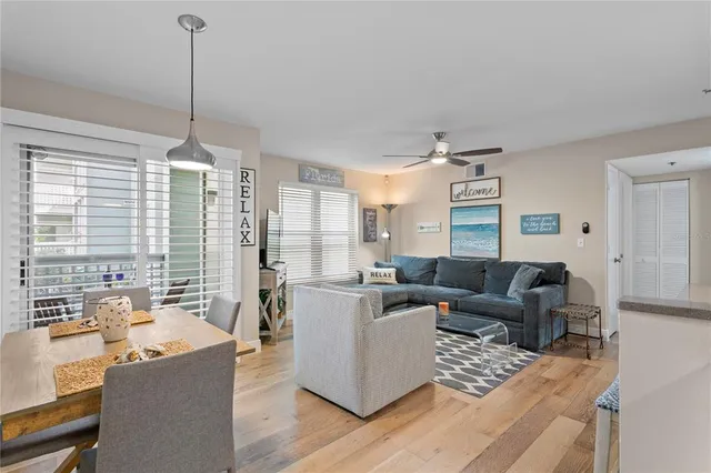 a living room with furniture and large windows