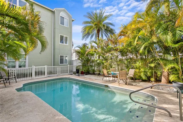 a swimming pool with outdoor seating and yard