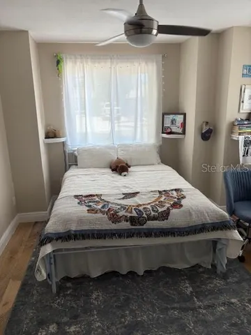 a bedroom with a bed and window