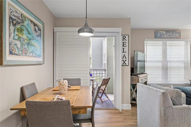 a dining room with furniture a window and wooden floor