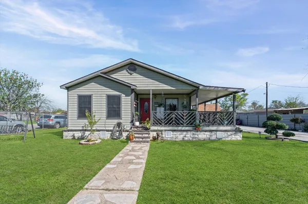 a front view of house with yard and outdoor seating