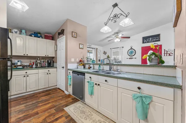 a kitchen with cabinets a sink and appliances