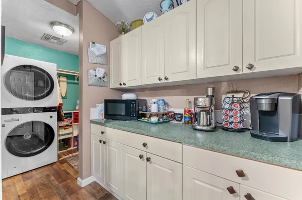 a view of a kitchen with fridge and rack