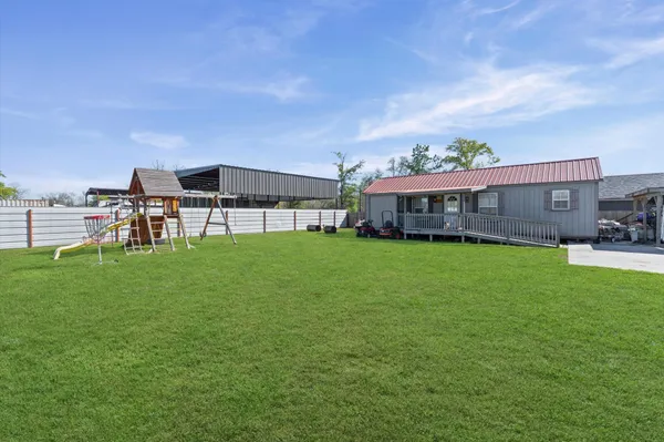 a view of a house with a backyard porch and sitting area