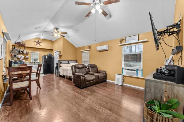 a living room with furniture a chandelier and a flat screen tv