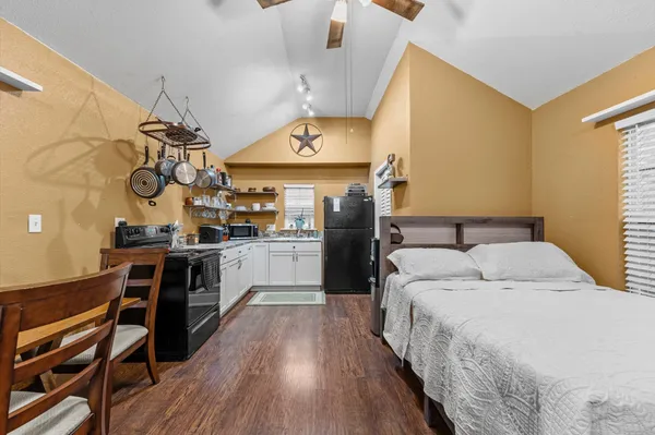 a bedroom with a bed and a desk