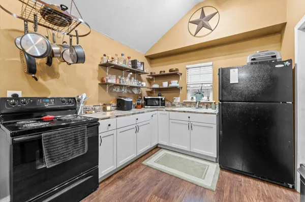 a kitchen with stainless steel appliances granite countertop a refrigerator a stove and a sink with dishwasher