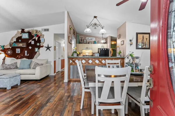 a view of a dining room with furniture and wooden floor