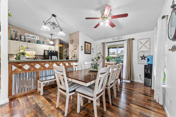 a view of a dining room with furniture and wooden floor