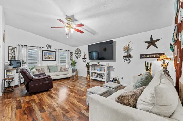 a living room with furniture and a flat screen tv
