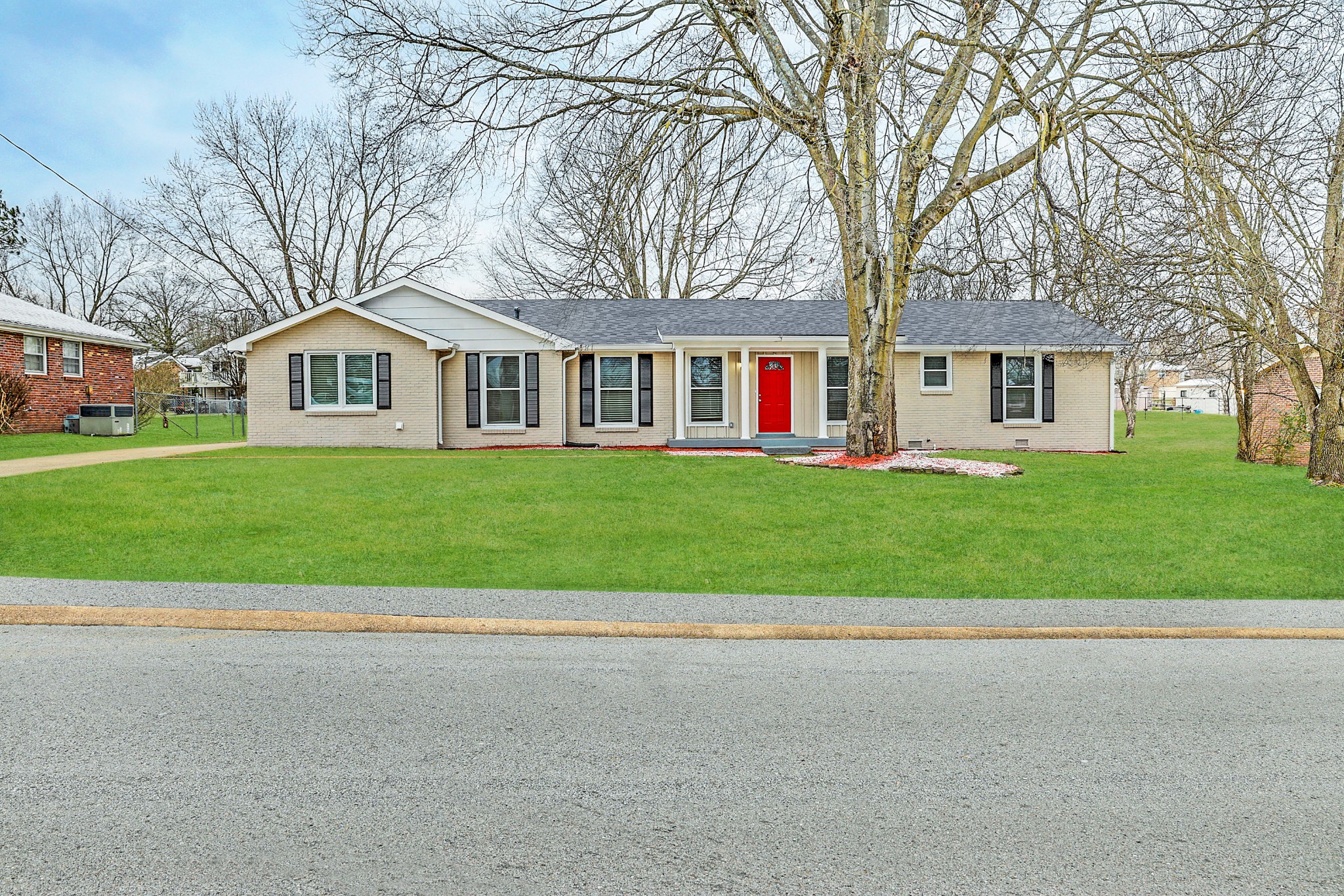 a front view of house with yard and green space