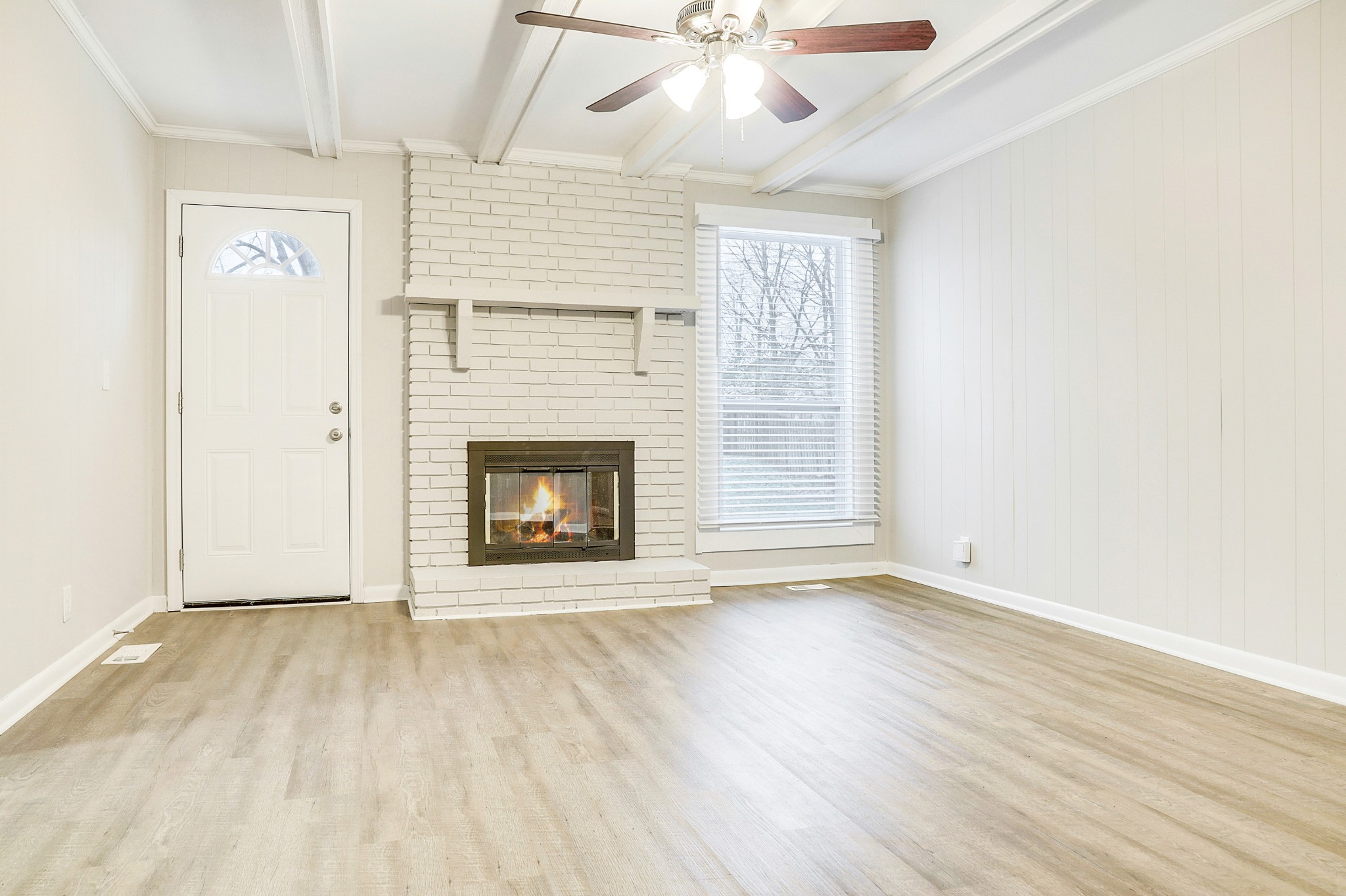 1320 Cheyenne Boulevard Madison, TN 37115 - Photo 17 of 26 an empty room with wooden floor a ceiling fan a fireplace and windows