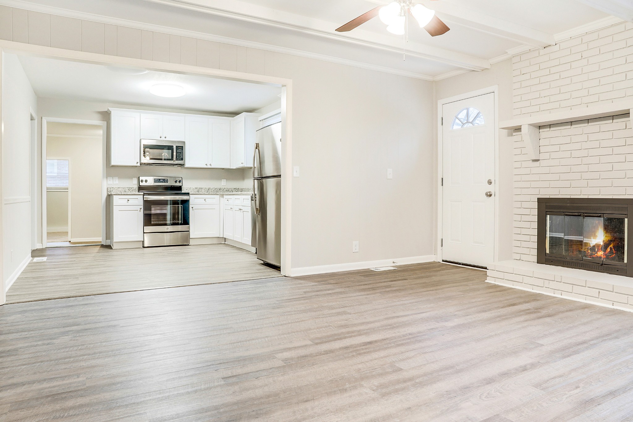 1320 Cheyenne Boulevard Madison, TN 37115 - Photo 5 of 26 an empty room with wooden floor a fireplace and windows