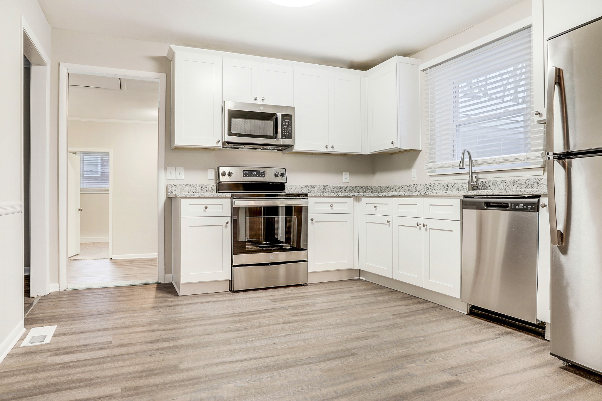 1320 Cheyenne Boulevard Madison, TN 37115 - Photo 6 of 26 a kitchen with cabinets stainless steel appliances and wooden floor