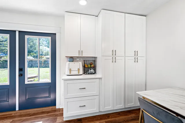 a view of kitchen with wooden floor and window
