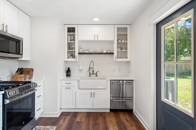 a kitchen with a sink stove and cabinets
