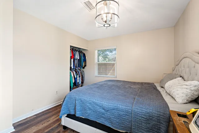 a bedroom with a bed and a chandelier