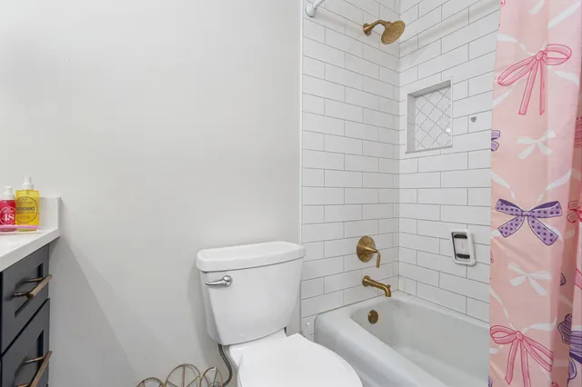 a bathroom with a toilet and a bath tub