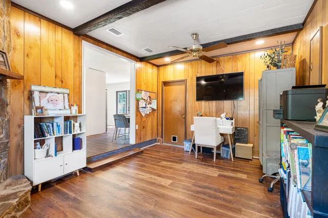 a view of a livingroom with furniture and a flat screen tv