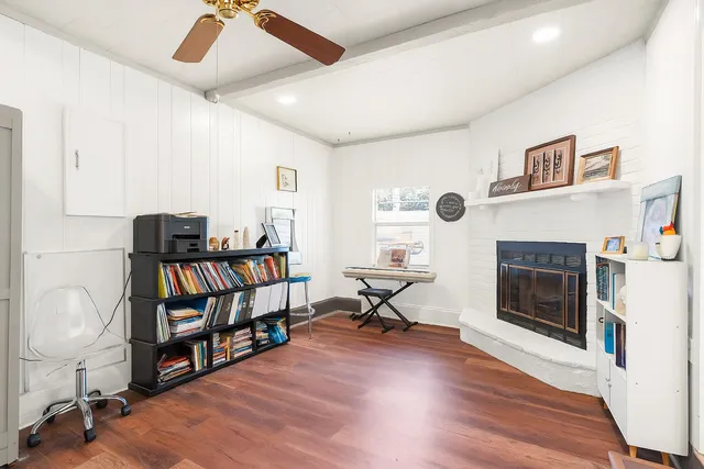 a living room with furniture a fireplace and a book shelf