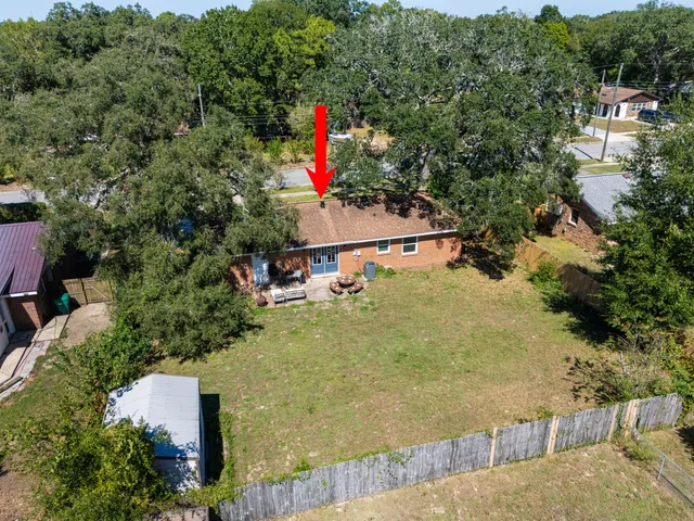 an aerial view of a houses with city view
